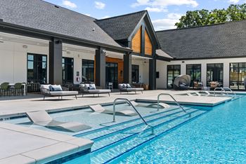 A large indoor swimming pool with a diving board.